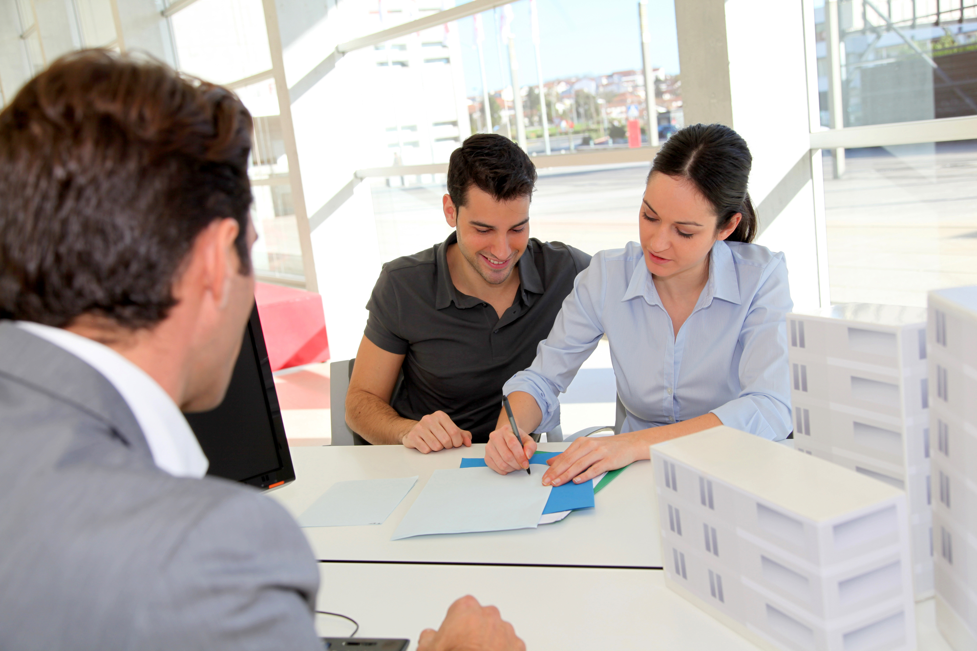 Couple Signing Documents